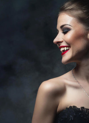 Gertraudt is wearing the 24" 925 Sterling Silver Rhodium Plrotected Paperclip chain with a small Rhodium protected Sterling Silver 2nd Generation Legacy Ankh. She wears Canine Classic 3D Printed Fangs by Sabretooth Fangs