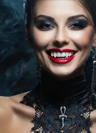 Martha wears a Special Limited Edition 2nd Generation Legacy Ankh in Rhodium Protected Sterling Silver with Vintage Onyx Stone. She wears Lost Boys 3D Fangs by Sabretooth Fangs. Makeup by JoHanna Moresco.
